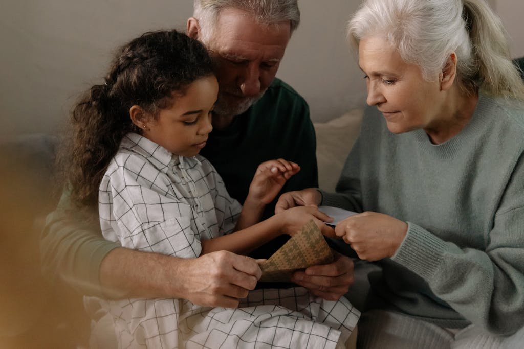 Grandparents making Craft Decoration with Granddaughter